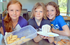 Xmas Cheer: Year 5 students Fleur Abbott, Kiva Cresswell and Noah Gourlay took charge of running the Christmas Stall