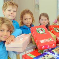 Operation Christmas Child at MRIS Reaching out: MRIS students, Sol, Finn, Evie, Fiona and Maisy with the Operation Christmas Child boxes.